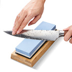 Kitchen knife being sharpened on the Seigan blue whetstone and bamboo base