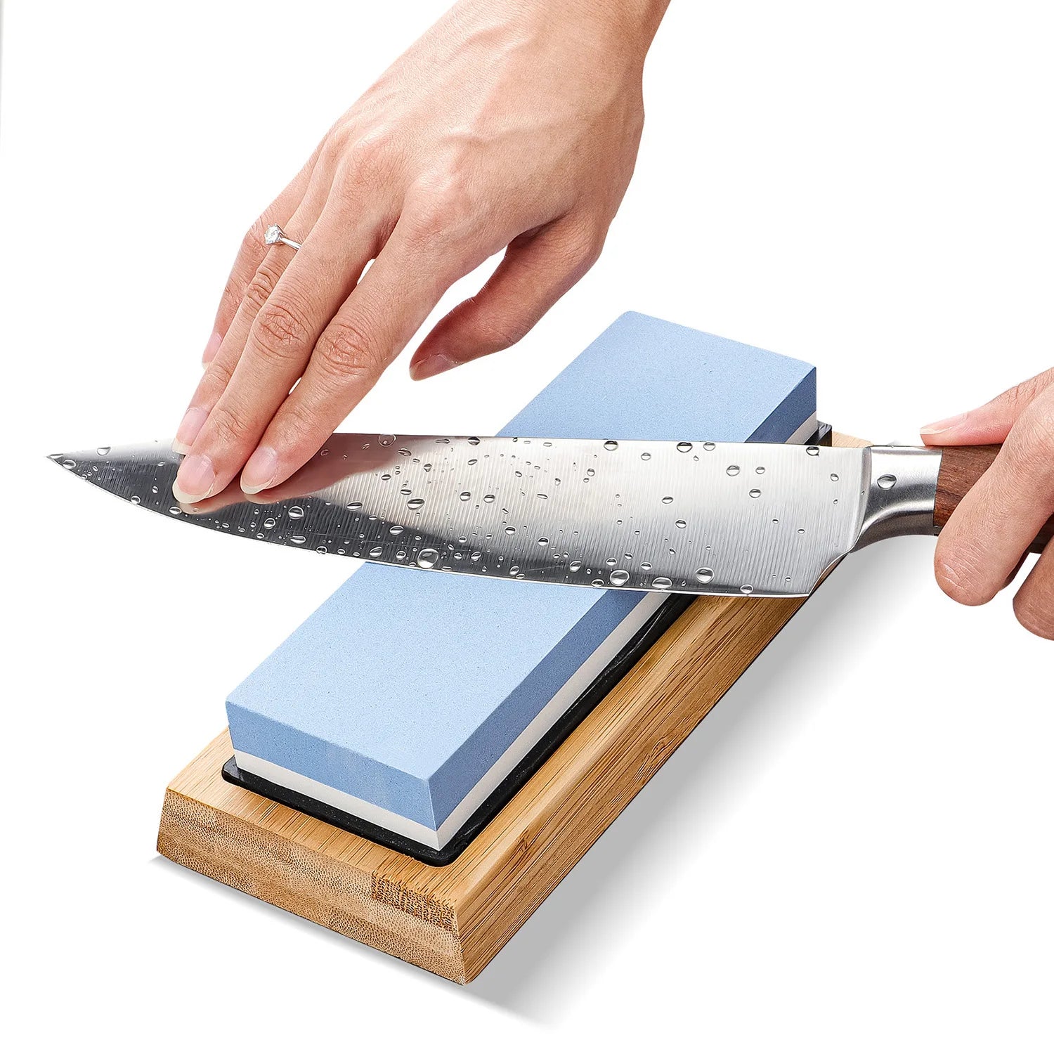 Kitchen knife being sharpened on the Seigan blue whetstone and bamboo base