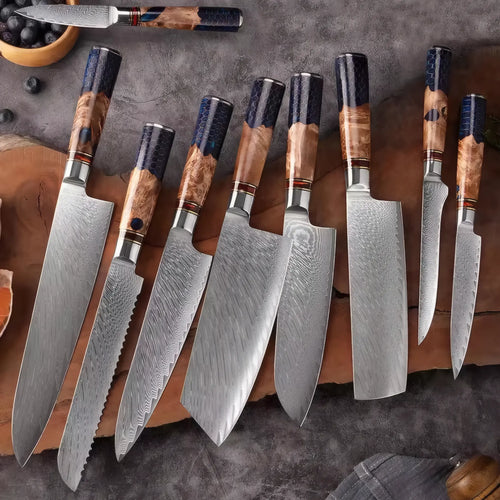Set of Damascus steel kitchen knives with wooden handles on a wooden cutting board.