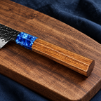 Close detail of the Aonami blue resin and natural wood knife handle